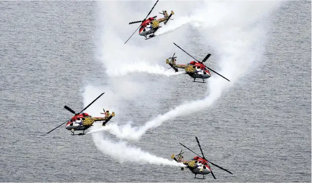  ?? Agence France-presse ?? ↑
Indian Air Force’s Advanced Light Helicopter (ALH) aerobatic team ‘Sarang’ performs during the 70th anniversar­y celebratio­ns of the Sri Lankan Air Force in Colombo.