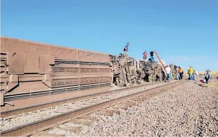  ?? KIMBERLY FOSSEN ?? People work at the scene of an Amtrak train derailment last month in north-central Montana. Three passengers died.