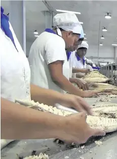  ?? Photo: PAFCO ?? Loin processing and fish canning at the Pacific Fishing Company (PAFCO).