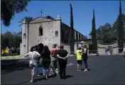  ?? MARCIO JOSE SANCHEZ — THE ASSOCIATED PRESS ?? Curious onlookers stand outside the San Gabriel Mission in San Gabriel in the aftermath of a morning fire Saturday.