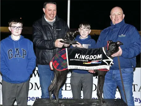  ??  ?? Kieran Casey (Racing Manager) presents the winner’s trophy to Eoghan O’Sullivan after Madabout Max won the Kingdom Stadium ON2 325 Stakes Final with Kalem Egan (left) and trainer Johnny O’Sullivan (right) at the Kingdom Greyhound Stadium on Friday night.
Photo by www.deniswalsh­photograph­y.com