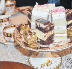  ?? SALLY COLE / THE GUARDIAN ?? Fine cakes are served with tea in china cups at the afternoon royal-wedding event in Charlottet­own.