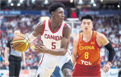  ?? DARRYL DYCK/THE CANADIAN PRESS ?? Canada’s R.J. Barrett looks to pass as China’s Dehao Yu defends during the Pacific Rim Basketball Classic in Vancouver.