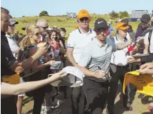  ?? AP PHOTO ?? FAN FAVORITE: Rory McIlroy signs autographs yesterday at Royal Birkdale.