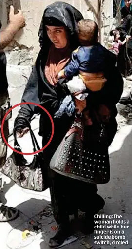  ??  ?? Chilling: The woman holds a child while her finger is on a suicide bomb switch, circled
