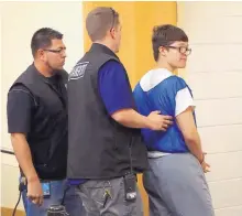  ?? ADOLPHE PIERRE-LOUIS/JOURNAL ?? Andrew Hubler, right, one of six teenagers involved in a 2015 fatal shooting during a night of “mobbing” is led out of District Court after a judge ruled Tuesday that he must remain in custody until he turns 21.