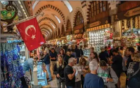  ?? (Bloomberg/Erhan Demirtas) ?? A Turkish national flag hangs at a souvenir store inside the spice bazaar in the Eminonu district of Istanbul in September.