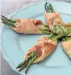  ?? ALYSHA WITWICKI ?? Asparagus bundles, wrapped in puff pastry, are flavored with prosciutto and Parmesan.