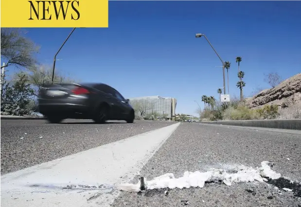  ?? CHRIS CARLSON / THE ASSOCIATED PRESS ?? Cars pass the scene in Tempe, Ariz., close to where a pedestrian was struck by an Uber vehicle Sunday night. The vehicle was in autonomous mode with an operator behind the wheel when the woman was hit. Uber suspended all of its self-driving testing...