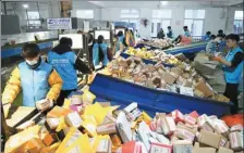  ?? ZHANG KAIHU / FOR CHINA DAILY ?? Employees of ZTO Express sort packages in Donghai county, Jiangsu province.