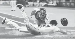  ?? JULIO AGUILAR/GETTY ?? Red Sox catcher Christian Vazquez tags out the Tampa Bay Rays’ Travis d’Arnaud as he tries to score on a headfirst slide in the third inning Saturday at Tropicana Field.