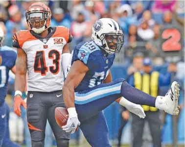  ?? THE ASSOCIATED PRESS PHOTOS ?? Tennessee Titans running back DeMarco Murray celebrates in front of Cincinnati Bengals free safety George Iloka after Murray scored on a 2-yard touchdown run in the first quarter Sunday in Nashville. The Titans won 24-20.