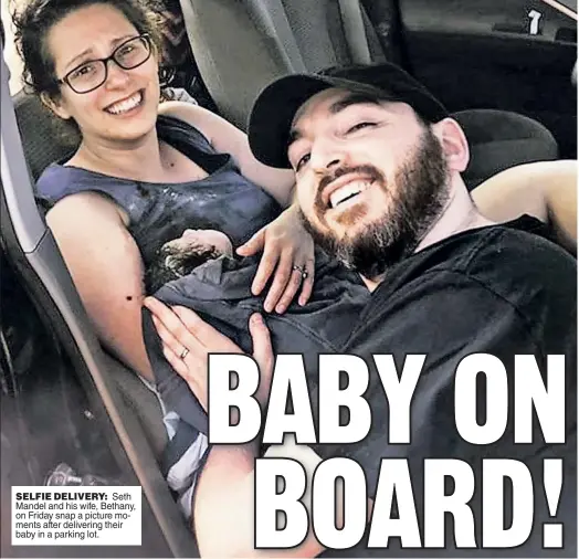  ??  ?? SELFIE DELIVERY: Seth Mandel and his wife, Bethany, on Friday snap a picture moments after delivering their baby in a parking lot.