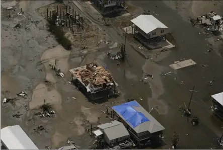  ?? MATT SLOCUM — THE ASSOCIATED PRESS ?? In this aerial photo, the remains of damaged homes are seen in the aftermath of Hurricane Ida, Monday in Grand Isle, La.