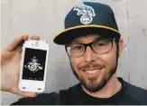  ?? Michael Macor / The Chronicle ?? A’s infielder Eric Sogard shows off a vote cast in his favor for the “Face of MLB” contest.