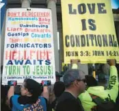  ?? Nashville, Tennessee. NICOLE HESTER/THE TENNESSEAN ?? Sign-bearing attendees congregate at an October rally against gender-affirming care at War Memorial Plaza in