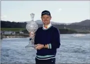  ?? ?? Justin Rose poses for a photograph with the trophy after winning the AT&T Pebble Beach Pro-Am.