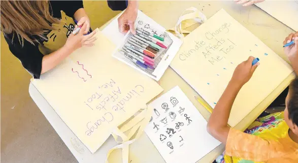  ?? AMY SHORTELL/THE MORNING CALL ?? The Lehigh Valley Chapter of the Citizens’ Climate Lobby hosted a climate camp for school-age children at the Emmaus Public Library on Wednesday morning. The camp teaches about climate change through research and fun activities such as crafts.