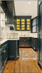  ?? ALLYSON LUBLOW — BAKES & KROPP VIA AP ?? This image provided by Bakes & Kropp shows a pantry room with cabinetry in satin-finished Midnight Dream paint. Counters and backsplash are quartz, providing an attractive counterpoi­nt.