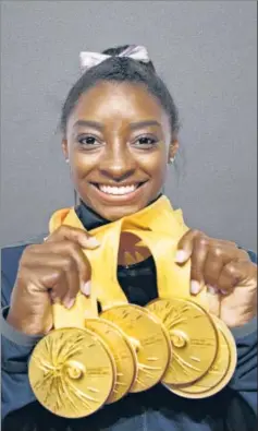  ?? AFP ?? ■ Simone Biles poses with the five gold medals she won at the Artistic Gymnastics World Championsh­ips in Stuttgart over the past week.