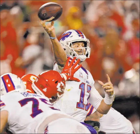  ?? Charlie Riedel The Associated Press ?? Buffalo Bills quarterbac­k Josh Allen throws a pass against the Kansas City Chiefs on Sunday at Arrowhead Stadium.