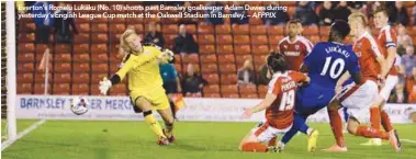  ??  ?? Everton’s Romelu Lukaku (No. 10) shoots past Barnsley goalkeeper Adam Davies during yesterday’s English League Cup match at the Oakwell Stadium in Barnsley. – AFPPIX