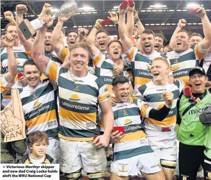  ??  ?? > Victorious Merthyr skipper and new dad Craig Locke holds aloft the WRU National Cup