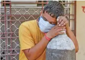  ?? — PTI ?? A family member of a Covid-19 patient rests as he waits to refill a cylinder with medical oxygen in Ajmer on Thursday.