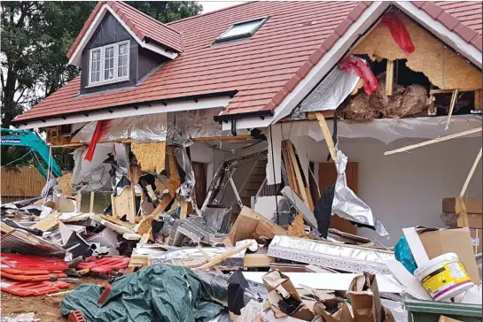  ??  ?? Trail of destructio­n: The retirement bungalows with walls and windows ripped out. Below: The digger said to have been used