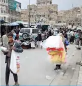  ??  ?? SANAA: Shoppers walk at a market in the capital Sanaa’s old quarter. The Baha’i community voiced fear that a court under Yemen’s Houthi rebels could order the mass expulsion of members of the faith. —AFP