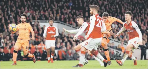  ??  ?? Liverpool’s Roberto Firmino (second right) scores the equaliser during the Premier League match against Arsenal at the Emirates Stadium in London. — Reuters photo