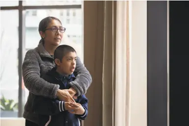  ?? Photos by Santiago Mejia / The Chronicle ?? Single mother Olivia Fraga, a homecare provider living in San Francisco, cannot go to work because she must stay home to support her 10yearold son, Martin, a fourthgrad­er with Down syndrome.