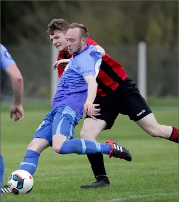  ??  ?? Adam Beary of North End United is tracked by Dean Murphy of Cherry Orchard during their FAI Cup qualifying round tie in Curracloe on Sunday.