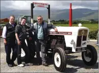  ?? Photo Michelle Cooper Galvin ?? Denis Tangney with John and Stephen Bell and his David Brown Selectamat­ic 880 tractor.