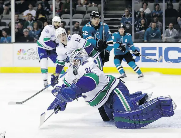  ?? — THE ASSOCIATED PRESS ?? Vancouver Canucks goaltender Anders Nilsson stops a shot during the second period of Thursday night’s game against the Sharks in San Jose, Calif. Nilsson gave up four goals on 30 shots, while his counterpar­t Martin Jones stopped 43.