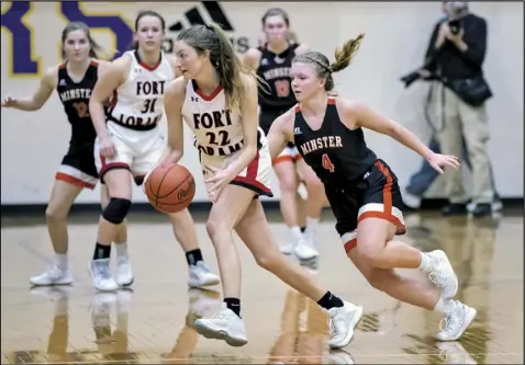  ?? Photo by David Pence ?? Ivy Wolf of Minster, right, chases after Fort Loramie’s Kenzie Hoelscher during Thursday’s Division IV regional semifinal game at Vandalia. The Lady Redskins won to advance to the regional finals.