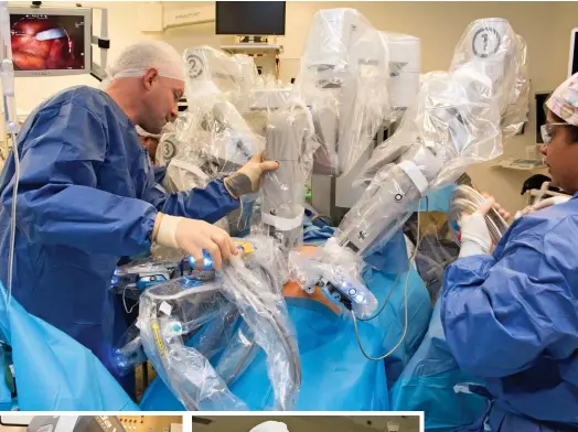  ??  ?? Groundbrea­king: Surgeon Greg Shaw puts the arms in place