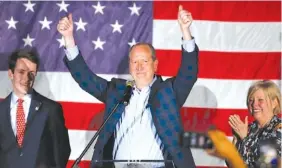  ?? AP PHOTO/NELL REDMOND ?? North Carolina 9th district Republican congressio­nal candidate Dan Bishop celebrates his victory in Monroe, N.C., on Tuesday with his son, Jack, left, and wife, Jo.