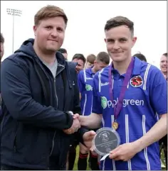  ?? Fourth official: Michael Farrell. ?? Rory O’Connor of Wexford Volkswagen presenting the man of the match trophy to Gavin O’Brien of Gorey Rangers.