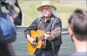  ?? Seth Wenig / AP ?? Woodstock veteran Arlo Guthrie plays a song at the original site of the 1969 Woodstock Music and Arts Fair in Bethel, N.Y., Thursday, Aug. 15, 2019.