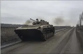  ?? EVGENIY MALOLETKA — THE ASSOCIATED PRESS ?? A Ukrainian serviceman drives an APC towards frontline positions near Bakhmut, Ukraine, on Wednesday.