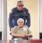  ?? EDDIE MOORE/JOURNAL ?? A Santa Fe County Sheriff’s Office deputy helps former priest Marvin Archuleta into the courtroom for his detention hearing in Santa Fe on Friday.