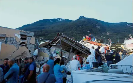  ??  ?? In ruins: Rescue workers checking a collapsed house after an earthquake hit the island of Ischia, off the coast of Naples.
