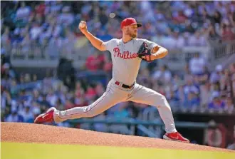  ?? AP PHOTO BY BRYNN ANDERSON ?? Philadelph­ia Phillies pitcher Zack Wheeler struck out 12 batters in eight scoreless innings Saturday to lead his team to a 2-1 road win against the Atlanta Braves.