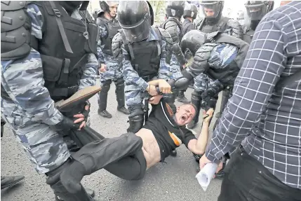  ?? EPA ?? Russian police officers detain a participan­t in an unauthoris­ed opposition rally in Tverskaya street in central Moscow on Monday.