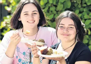  ?? REPORT: JOHN GIBB PHOTO: PETER MCINTOSH ?? University of Otago students Maraea te Waitoatoa Golias (18, left) and Olivia Williams (18), both of Wellington, enjoy their hangi food at the University of Otago Maori Centre during O Week events yesterday. Students flocked to the hangi food at the Castle St centre, and one participan­t later later posted on social media that the hangi food had been ‘‘sooo good’’.