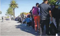  ?? ANA RAMIREZ U-T ?? Migrants are offered a warm meal, access to Wi-Fi and other services at an undisclose­d location in San Diego last month.