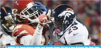  ??  ?? KANSAS CITY: Denver Broncos running back Devontae Booker (23) tries to fend off Kansas City Chiefs defensive back Ron Parker (38) during the second half of an NFL football game in Kansas City.