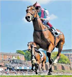  ??  ?? Sunny outlook: Enable, ridden by Frankie Dettori, goes clear yesterday