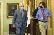  ?? SUSANWALSH/ASSOCIATED PRESS ?? Senate Majority Leader MitchMcCon­nell of Ky., is followed by a reporter as he arrives on Capitol Hill in Washington, Wednesday.